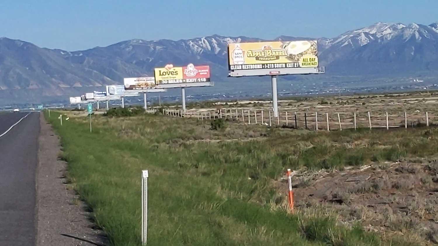 Billboards one after another along a highway in Utah.